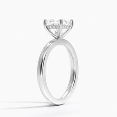 a white gold engagement ring with a princess cut diamond