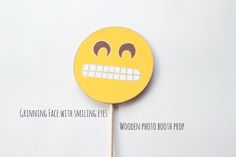 a yellow lollipop with an emoticive face drawn on it's side