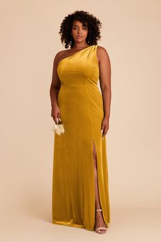 a woman in a yellow dress posing for the camera with her hand on her hip