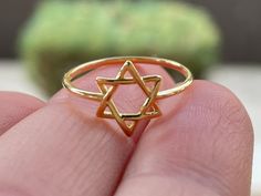 Gold Plated Star of David Ring * Magen David Ring * Jewish Jewelry * Six Wings Kabbalistic Unisex Religious * Spiritual * Minimalist Sweet and simple Star of David ring Material: 14K Gold Plated over 925 Sterling Silver  Qty: 1 pc.  Size: Multiple Sizes. Please choose your size from the drop down.  If you want this ring in silver please click here: https://www.etsy.com/listing/723831895/star-of-david-sterling-silver-jewish?click_key=eaffd10312aadff9d6044dbf47c8363ea4abb533%3A723831895&click_sum=3555cd50&ga_search_query=David&ref=shop_items_search_2&pro=1&frs=1 Thank you for visiting my shop! Star Of David Ring, Star Of David Jewelry, Jewish Ring, Jewish Artwork, Spiritual Ring, Jewish Stuff, David Ring, Boho Rings Gold, Clean Sterling Silver