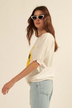 Distressed, garment washed graphic t-shirt. Vintage-style hammock and palm trees smiley face graphic print with "Love Life" text. Torn and distressed detailing at neckline, cuffs, and hem. Round neckline. Short sleeves. Drop shoulder. Oversized fit. 100% Cotton. Imported top designed and printed in LA. Model wears size S. Distressed Relaxed Summer Tops, Relaxed Distressed Summer Tops, Relaxed Distressed Tops For Summer, Summer Crew Neck T-shirt With Frayed Hem, Relaxed Summer Tops With Frayed Hem, Relaxed Summer Tops With Screen Print, Casual Frayed Hem T-shirt For Summer, Distressed Summer T-shirt For Everyday, Distressed T-shirt For Everyday Summer Wear