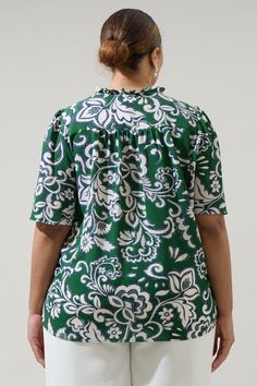 Add a pop of green into your off-duty wardrobe with this Harriet Floral Ruffle Split Neck Dupont Top. A split neckline with short flouncy sleeves adorns this top. The relaxed fit gives it a pretty look, and it can be tied at the neck and tucked into high waisted linen pants top finish off. - Split neck- Tie neck- Ruffle trim- Puffed short sleeves- Color: Cream GreenSize + Fit - Model is 5'9" and wearing size 2X- Measurements taken from size 2X - Chest: 28 1/2"- Length: 29" Fabric Self: 98% Polye Green Floral Print Short Sleeve Top, Green V-neck Top With Ruffles, Green Casual Flutter Sleeve Top, Casual Green Top With Flutter Sleeves, Green Floral Print Blouse With Ruffle Sleeves, Casual Green Split Neck Top, Green Flutter Sleeve Blouse For Summer, Green Ruffle Sleeve Top With Floral Print, Green Top With Ruffle Sleeves And Floral Print