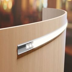 a close up view of a wooden cabinet with metal handles and an electronic device on the door