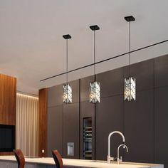 a modern kitchen with an island and bar stools