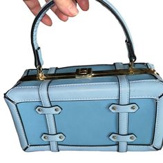 Long Shoulder Strap Included. Closes Tight . No Inside Pockets. Luggage Style! Approx. 9 “ Wide By 5” Tall , Depth Is Approx 4” . Strap Measures 52” . Goldtone Hardware. Vegan, Leadfree . Striped Lining Is 100% Polyester, Vegan Pu Exterior. Light Blue Rectangular Office Shoulder Bag, Trendy Blue Box Bag For Formal Occasions, Trendy Blue Square Box Bag, Blue Rectangular Case Bag For Daily Use, Blue Rectangular Box Bag For Office, Blue Shoulder Box Bag For Office, Chic Blue Box Bag For Office, Rectangular Blue Box Bag For Office, Light Blue Rectangular Bag For Formal Occasions