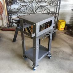 a metal workbench sitting on top of a cement floor