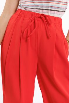 Embrace the warmth of spring and summer with our Coral Pants, featuring two front pockets and one back pocket. These pants offer a relaxed fit with loose legs, making them perfect for the warmer seasons. The drawstring closure and elasticated waist ensure a perfect fit for everyone. Made from 100% polyester, these pants are lightweight and comfortable for everyday wear. Model Info: Model is wearing size S. Model's measurements: 33-24-35, Height: 5'9''. Key Features: Regular fit with a regular wa Coral Pants, Tan Scarf, Scarf Hat, Jeans Jumpsuit, Hat Hairstyles, Workout Pants, Short Pants, Sweater Top, Dress Skirt