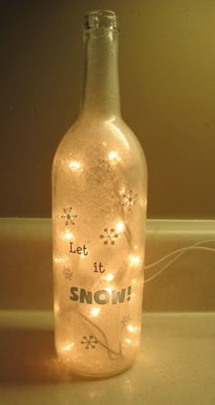 a bottle that has lights in it and the words let it snow written on it