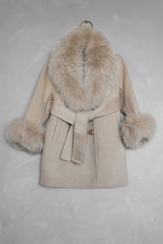 Take on the world in our Beige Wool Fur Coat! Made with genuine attachable Natural Fox Fur, the softest cashmere, and Natural Wool, this luxurious design from our Mini Me and Mama Top Luxury Collection is a must-have for moms and their daughters. It is a timeless belted peacoat design with a double-breasted domed golden button closure and welt pockets. Be unstoppable and stylish with the Best-Selling Coat for you and your little one! Fabric: 10% Cashmere, 90% Wool 100% Natural Fox Fur Beige Fur Coat, Beige Wool Coat, Mom And Daughter, Luxurious Design, Luxury Collection, Modest Fashion Outfits, Fall Looks, Winter Looks