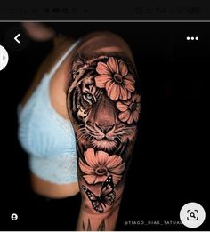 a woman's arm with a tiger and flowers on it