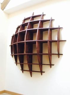 a circular wooden shelf mounted to the side of a wall