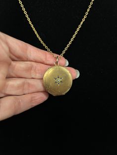 This lovely gold-filled European seed-pearl-centered starburst locket will speak volumes with its elegant simplicity. It features an engraved star with blue-stone-studded delicate rays and an interesting engraved pattern along its perimeter. This gem of a locket hangs on a cool vintage textured gold-filled chain. Hinges open from the top. Celestial Pendant Locket Jewelry, Gold Pendant Locket Necklace With Birthstone, Engraved Yellow Gold Star Of David Jewelry, Antique Yellow Gold Star Jewelry, Yellow Gold Brass Jewelry With Star Charm, Gold Wedding Jewelry With Star Charm, Engraved Star-shaped Yellow Gold Necklace, Engraved Star Yellow Gold Necklace, Elegant Star-shaped Brass Jewelry