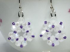 two pairs of earrings with purple and white beads