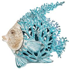 a blue and white fish figurine sitting on top of a coral