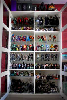 a white shelf filled with lots of action figures