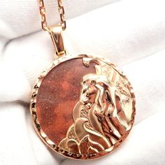 a gold plated necklace with an image of jesus on it