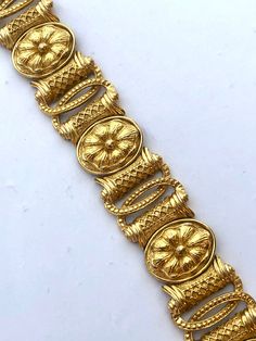 Beautiful Etruscan Egyptian Revival style bracelet in a rich golden color. The piece is high end, featuring an intricate floral design. It measures about 7.5 and weighs about 54.4g! Beautiful vintage condition and stamped both Trifari and Saltz on the back.  I have the matching earrings separately listed as well. See the last photo for an image of the set. Please see all photos and ask any questions. All items sold as found from estates and my own personal family collection. Thank you for shoppi Luxury Hand Set Festive Sets, Luxury Brown Hand-tooled Jewelry, Luxury Ancient Style Collectible Jewelry, Medieval Jewelry Egyptian, Luxury Ceremonial Jewelry With Motifs, Cheap Gold Antique Finish Jewelry, Luxury Antique Finish Jewelry For Wedding, Etruscan Jewelry Romae Jewelry, Byzantine Jewelry Egyptian