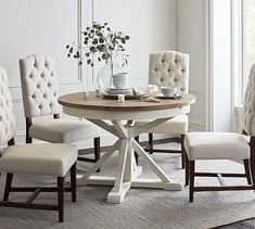 a dining room table with four chairs around it