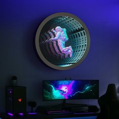 a computer desk with a monitor, keyboard and mouse in front of a purple wall