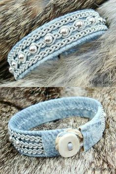 two bracelets with buttons on them sitting next to each other in front of some fur