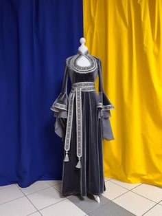 The dress is made from artificial velvet in gray color. Sleeves and a belt are decorated with the wide silver knitted and woven braid. The main decoration of a dress is sleeves which beautifully fall down and have the real elfin appearance. There aren't any fasteners on the dress, thanks to ability of fabric it is good to stretch. The suit consists of a dress and a belt. Material: velvet. The dress can be made in any size. Production of a dress takes 7-10 working days. Elven Style Wedding Dress With Historical Design, Elven Wedding Dress With Historical Design, Elegant Floor-length Medieval Dress For Festivals, Elegant Floor-length Medieval Dress, Gothic Floor-length Dress For Medieval Festivals, Elegant Medieval Festival Costume Dress, Elegant Medieval Festival Costume Party Dresses, Elegant Dresses With Historical Design For Larp, Elegant Floor-length Medieval Costume Dress