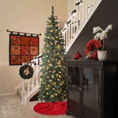 a decorated christmas tree sitting next to a banister