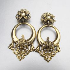 "These incredibly rare earrings from the 1980s-1990s are signed, \"Laggia Venezia\" which is the mark of designer Alfred Laggia of Venice, Italy. These earrings are 4\" long and are made of a light weight gold-tone metal. They have clip backs and crystal rhinestones with dangling big hoops. They are in excellent condition with no wear or damage.    FREE SHIPPING within the USA!     9609" Vintage Pierced Hoop Earrings For Wedding, Vintage Brass Hoop Earrings, Vintage Pierced Hoop Earrings For Formal Events, Vintage Formal Hoop Earrings, Vintage Pierced Hoop Earrings For Formal Occasions, Vintage Hoop Jewelry For Party, Vintage Clip-on Hoop Earrings For Party, Vintage Metal Hoop Earrings For Formal Occasions, Rare Earrings