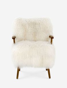 a white chair with wooden legs and a sheepskin seat cover on it's back