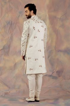 White hand embroidered sherwani with zardozi and aari in floral motifs. Paired with matching pintuck kurta and churidar.
Component: 3
Pattern: Embroidered
Type Of Work: Floral
Neckline: Mandarin
Sleeve Type: Long
Fabric: Linen Silk
Color: White
Other Details: 
Floral motifs
Occasion: Groom,Wedding - Aza Fashions Jatin Malik, Embroidered Sherwani, White Hand, Sherwani, Churidar, Floral Motifs, Custom Tailoring, Wedding Groom, Embroidered Silk