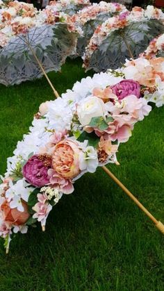 several umbrellas with flowers on them sitting in the grass