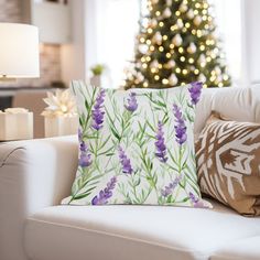 a living room filled with furniture and a christmas tree in the backgrounnd