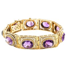 Vintage 40ctw Amethysts & Seed Pearls Bracelet In Yellow Gold Indulge in the opulence of yesteryear with this magnificent vintage bracelet, lovingly crafted from 14kt yellow gold. It boasts an impressive array of oval amethysts, collectively weighing 40 carats, radiating with exquisite clarity and a lustrous purple. Accentuating its splendor are the delicate seed pearls, adding an air of refined elegance. This substantial piece measures 7.5 inches in length. It weighs a notable 44.8 grams, makin Pearls Bracelet, Modern Bracelets, Vintage Bracelet, Seed Pearl, Vintage Bracelets, Pearl Bracelet, Jewelry Bracelets, Violet, Seeds