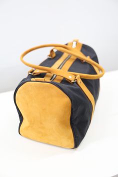 This Weekender Duffle is the perfect travel bag for your next getaway! It holds all of the essentials without weighing you down, all while looking stylish + pairs perfectly with our matching toiletry bag. Materials: leather, black canvas, kikoi lining, metal zipper Dimensions: 17 in x 8 in x 9.5 in Kikoi is a traditional Kenyan cloth, woven from cotton yarn, making it very strong and easy to wash. Each item is handmade and measurements may vary slightly. As leather is a natural material, color t Luxury Bags With Zipper Closure For Weekend Trips, Luxury Black Bag For Trip, Luxury Black Travel Bag For Trip, Luxury Black Travel Bag, Luxury Black Duffle Bag For Trip, Black Coated Canvas Travel Bag With Luggage Sleeve, Black Travel Bag With Luggage Sleeve In Coated Canvas, Black Coated Canvas Duffle Bag For Travel, Black Bags With Leather Trim For Trip