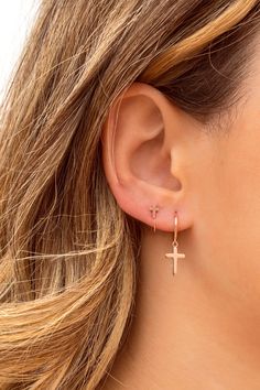 The Croix earrings are small hoops with a cross-shaped pendant. This minimalist and easy-to-combine earrings are really comfortable due to their lightness. They look great on both adults and children. Perfect for a gift, too. Features: * Inner diameter: 9 mm. * Outer diameter: 11 mm. * Cross length: 13 mm. * They are sold in singles and in pairs. Both options are available on the dropdown menu. * All of our jewelry is made with sterling silver (925 mm) and our gold jewelry is gold plated in 18K Minimalist Hypoallergenic Cross Earrings, Second Ear Piercing, Jewelry Piercing, Tiny Cross, Body Jewelry Piercing, Helix Earrings, Earrings Ear, Christian Jewelry, Cartilage Piercing