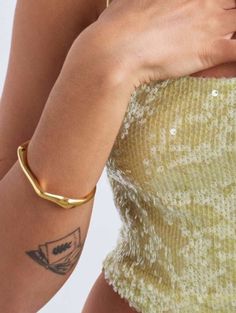 The Arc Cuff is the bangle that's here to make a statement and steal the show. This beauty is crafted with a brass base, giving it the perfect weight and flow. We've added a layer of bonded 14k gold, making it not only stunning but also durable. It's the superhero of cuffs, ready to withstand the test of time and fashion trends. Features: Waterproof and Tarnish Resistant 55mm x 65mm inner diameter Opening can be slightly adjusted Gold Party Bracelet With Oyster Detail, Chic Oyster Bracelet For Party, Chic Gold Cuff Bracelet With Oyster Detail, Yellow Gold Brass Bracelets For Parties, Modern Gold Bangle Bracelet For Party, Yellow Gold Cuff Jewelry For Party, Chic Gold Oyster Bracelet Cuff, Chic Gold Oyster Cuff Bracelet, Glamorous Gold Bangle Cuff Bracelet