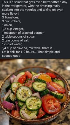 a bowl filled with cucumbers and tomatoes on top of a counter next to a recipe