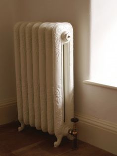 an old radiator in the corner of a room