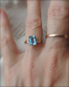 sweetest blue topaz ring - 4 tiny cut diamonds - fine condition - marked carlyle - size 5 - 14k gold - pretty ring - delicate strength - emerald cut cabochon - graceful setting - lovely cocktail ring - vintage 14k ring - timeless refinement Blue Emerald Cut Ring With Rose Cut Diamonds, Emerald Cut Blue Ring With Rose Cut Diamonds, Blue Topaz Ring With Rose Cut Diamonds For Promise, Blue Emerald Cut Topaz Ring In 14k Gold, Blue Emerald-cut Topaz Ring In 14k Gold, Heirloom Style Emerald Cut Topaz Ring With Accent Stones, Heirloom Emerald Cut Topaz Ring With Accent Stones, Blue Topaz 14k Gold Promise Ring, 14k Gold Topaz Ring With Diamond Accents