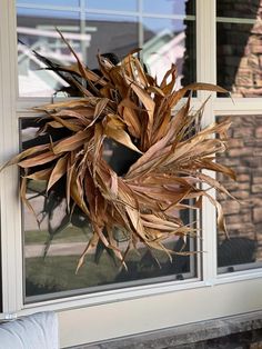 a wreath hanging on the front door of a house with no one inside or outside