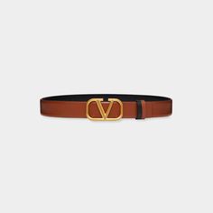 Valentino Garavani reversible calf leather belt. Approx. 1.1"W (3cm). Polished golden VLOGO buckle. Made in Italy. Brown Leather Belt With Logo Plaque, Designer Leather Belt Buckles With Logo, Luxury Business Belt With Logo Plaque, Luxury Business Belts With Logo Plaque, Designer Leather Belt With Logo, Classic Brown Belt With Logo Plaque, Luxury Belt Buckles With Metal Logo, Luxury Business Belt Buckles With Metal Logo, Luxury Metal Logo Belt Buckles For Business