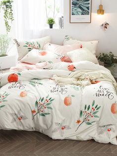 a bed with white sheets and oranges on it in a room next to a window