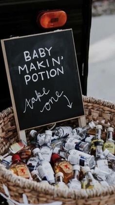 a basket filled with lots of bottles next to a chalkboard that says baby marlin's potion make money