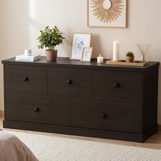 a bedroom with a dresser and pictures on the wall