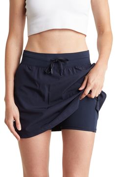 Get moving in this lightweight skort fashioned with a comfortable elastic-drawstring waistband and handy pockets. Elastic/drawstring waist Slant pockets 89% polyester, 11% spandex Machine wash, tumble dry Imported Model stats: 5'10" height, 32" bust, 25" waist, 36" hip. Model is wearing size Small. Casual Travel Bottoms With Drawstring, Casual Skort With Elastic Waistband And 4-way Stretch, Casual Swim Skirt For Sports With Elastic Waistband, Casual Swim Skirt With Elastic Waistband For Sports, Casual Short Swim Skirt, Casual Navy Skort, Casual Go-dry Short Swim Skirt, Casual Short Swim Skirt With Go-dry Technology, Casual Short Swim Skirt With Go-dry Feature