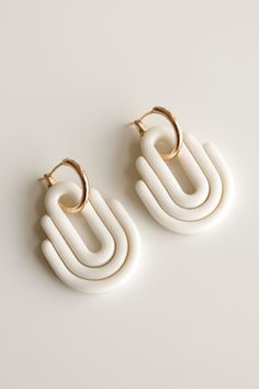 Art Deco collection with a vibrant color palette, bold graphics, and expressive geometric textures that give your style a modern touch. SIZE AND MATERIAL *Earrings are made with 18k gold-plated hoops. *Size: 40 x 25mm ( 1.57 x 0.98 in) *Lightweight: 11g a pair *Porcelain glazed from one side The lightweight design makes ceramic earrings ideal for everyday wear. Porcelain earrings are designed and handmade in our Riga studio. No two pairs are identical. That's the beauty of handcrafted jewelry! All Rozenthal jewelry is beautifully packaged in a gift box. SHIPPING AND HANDLING Note that shipping and handling will take up to 3 days from the day of your purchase. All Rozenthal jewelry is beautifully packaged in a gift box. FREE SHIPPING Latvia: 1 - 3 Business days Europe: 7 - 12 Business days Bold Geometric Earrings With Bold Design, Bold Geometric Designed Earrings, Bold Geometric Earrings, Bold Drop Earrings With Bold Design, Bold White Jewelry For Gift, Bold White Jewelry For Gifts, Modern White Geometric Earrings, Trendy Small Hoop White Jewelry, Trendy White Small Hoop Earrings