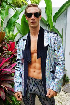 Light up the night sky in this mens holographic lightning bolt jacket. Our sequin blazer is the perfect statement jacket for all of your special occasions. We love this piece for everything from a wedding or birthday party to the red carpet or a music festival. FEATURES: Velvet lightning bolt collar, pockets and elbow patches Fully lined with our signature satin 3 pockets including 1 inside breast pocket Crafted with durable, high quality reversible holographic silver and black sequins that chan Lightning Outfit, Sparkly Blazer, Glam Rock Style, Rock Style Men, Glitter Jacket, Sequin Coats, Festival Outfits Men, Festival Attire, Drag King