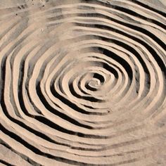 a circular design made out of sand on the beach