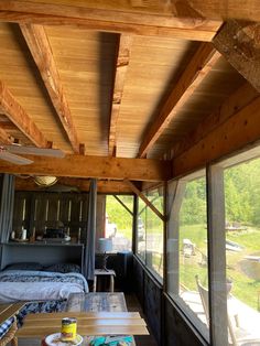 the inside of a small cabin with wood floors and ceiling fans on each side of the room