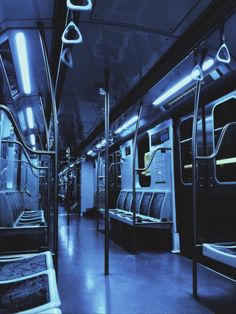 the interior of a subway car with blue lighting