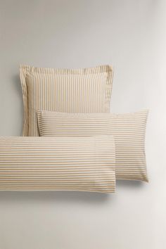 two striped pillows on top of each other